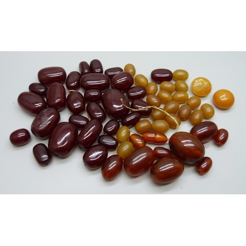 985 - A collection of loose amber and amber colour beads, 125g