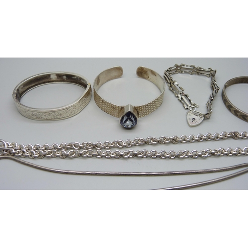 993 - A collection of silver bangles, bracelets and chains, 111g, together with a silver necklace with pla... 