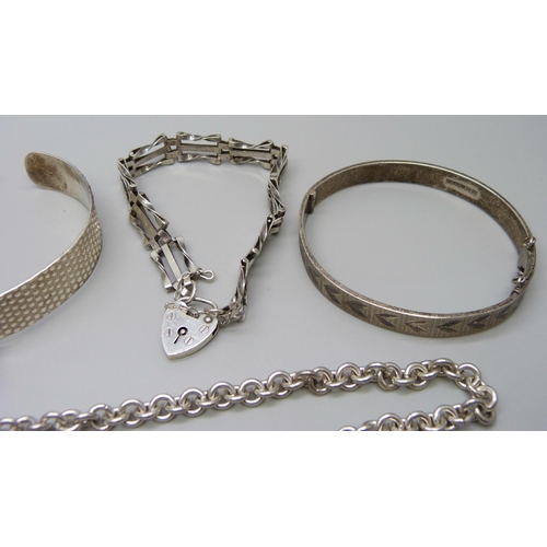 993 - A collection of silver bangles, bracelets and chains, 111g, together with a silver necklace with pla... 