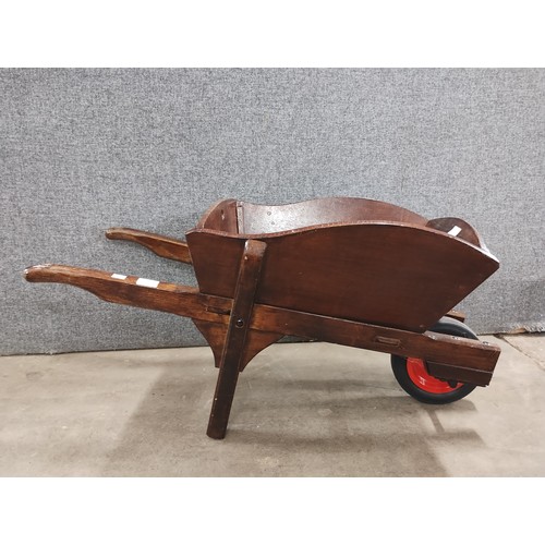 290 - A stained beech wheelbarrow planter