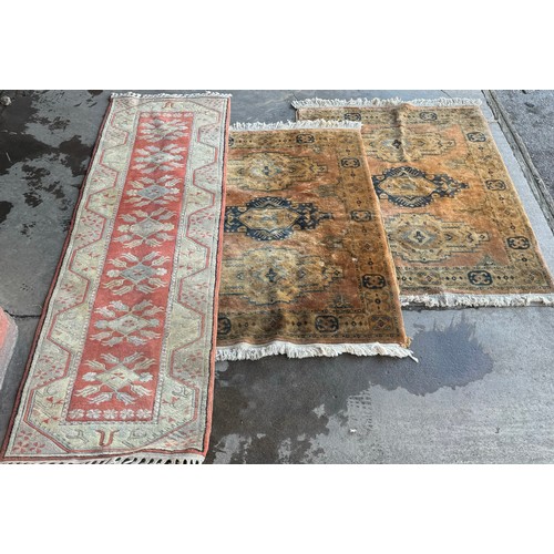 247 - A terracotta ground and one other rug (190cm x 123cm)x2 (285cm x 81cm)