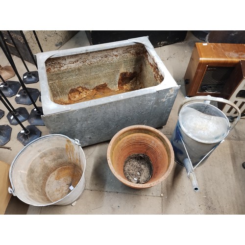 296 - A galvanised watering can, bucket, water tank and a terracotta planter