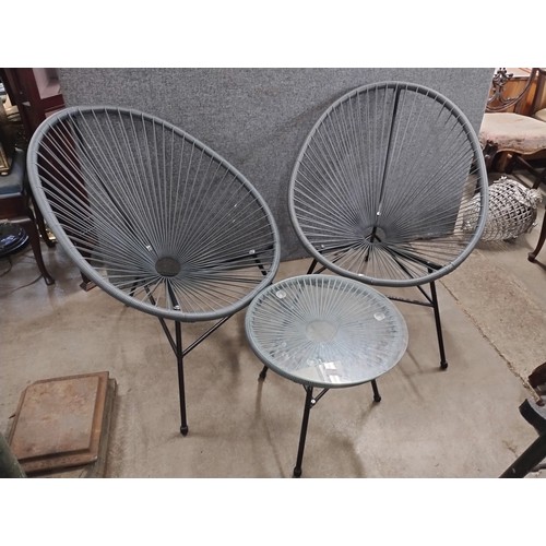 301 - A glass topped patio table and two ball chairs