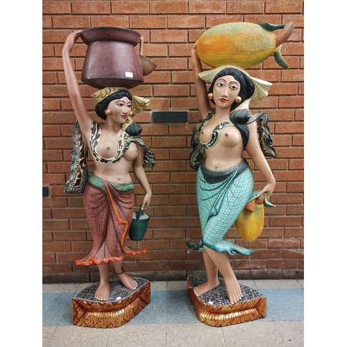 306 - A pair of large Spanish carved and hand painted figures of ladies