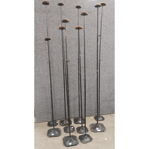 310 - Ten early 20th Century tall metal hat stands