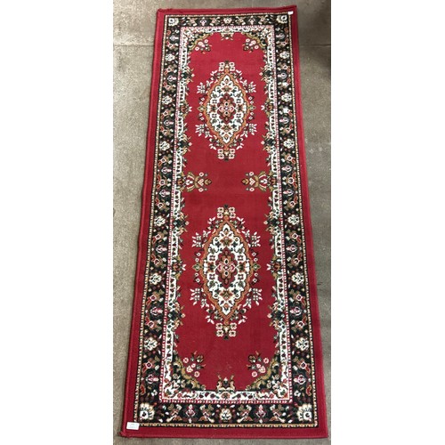 245 - A red ground runner (198cm x 66cm)