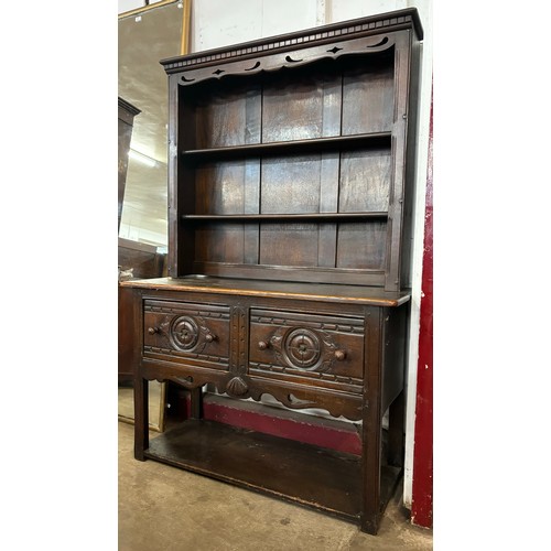 155A - A 17th Century style carved oak dresser