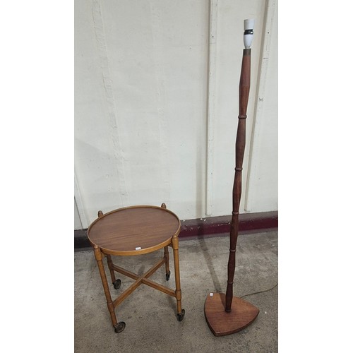 38 - A teak circular cocktail trolley and a standard lamp