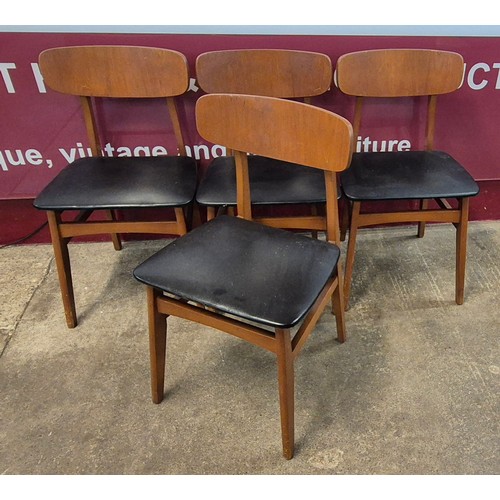 53 - A set of four teak and black vinyl dining chairs