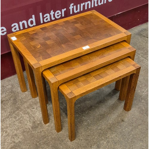 81 - A teak parquetry topped nest of tables