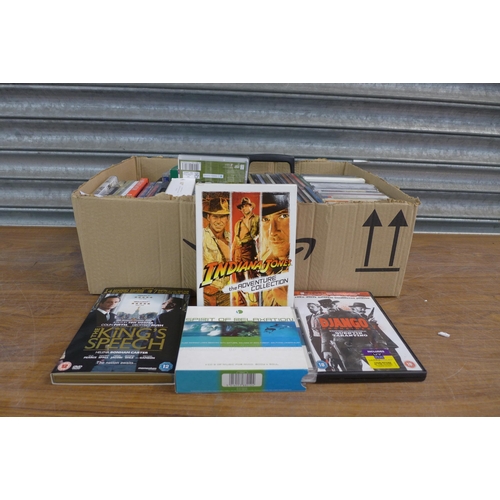 A box of assorted DVDs, CDs and tapes