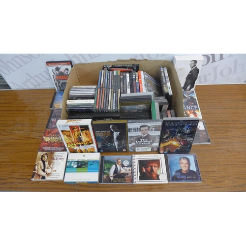 A box of assorted DVDs, CDs and tapes