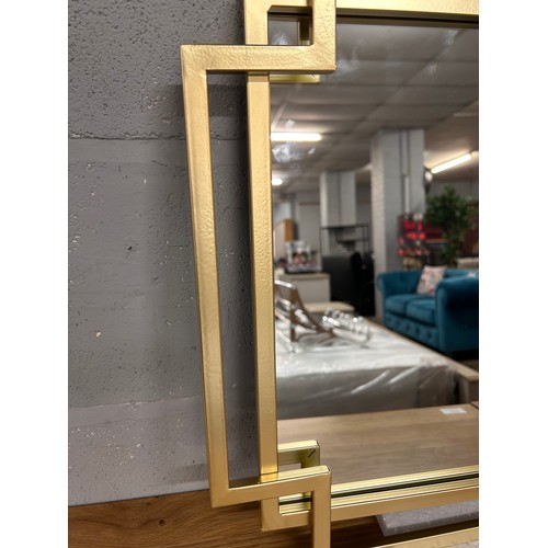 3077 - A gold metal framed Art Deco style mirror, 95 x 48cm