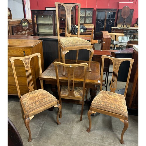 153 - An early 20th century oak draw-leaf table and four Queen Anne style dining chairs