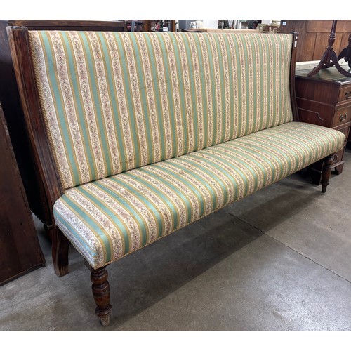 174 - An early 20th Century mahogany and fabric upholstered settle