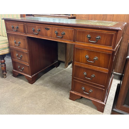 176 - A Regency style mahogany and green leather topped pedestal desk