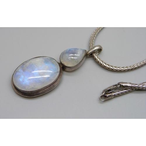 1002 - A large silver moonstone pendant on a silver chain, 37g, 5.8cm pendant