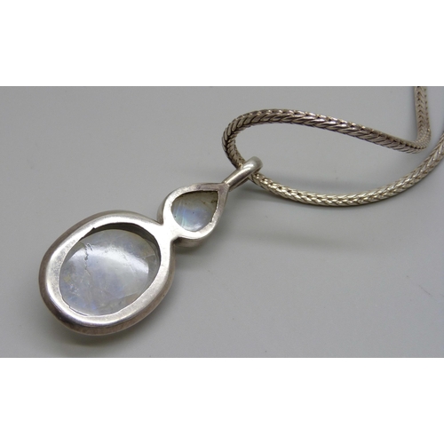 1002 - A large silver moonstone pendant on a silver chain, 37g, 5.8cm pendant