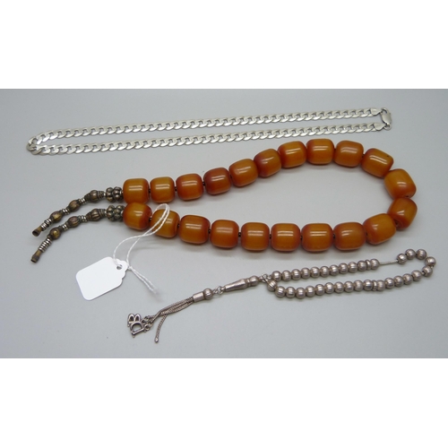 1010 - A butterscotch amber coloured necklace, a silver curb chain, 28g, and a silver bracelet, 16g