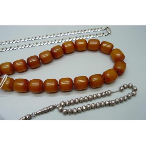 1010 - A butterscotch amber coloured necklace, a silver curb chain, 28g, and a silver bracelet, 16g