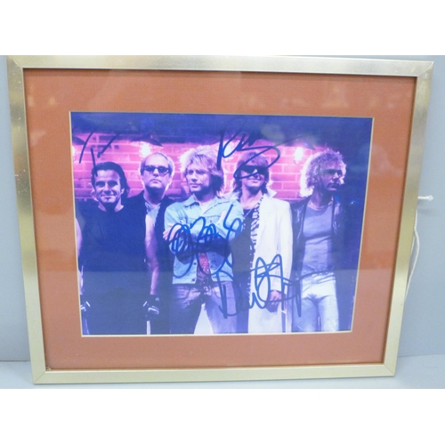 613 - A Bon Jovi signed picture display, no CoA, frame 33.5cm wide