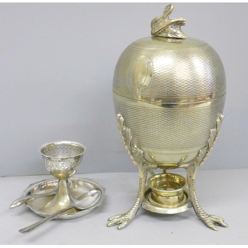 617 - A plated egg warmer by Mappin and Webb, a pair of silver salt spoons, an egg cup and two other spoon... 