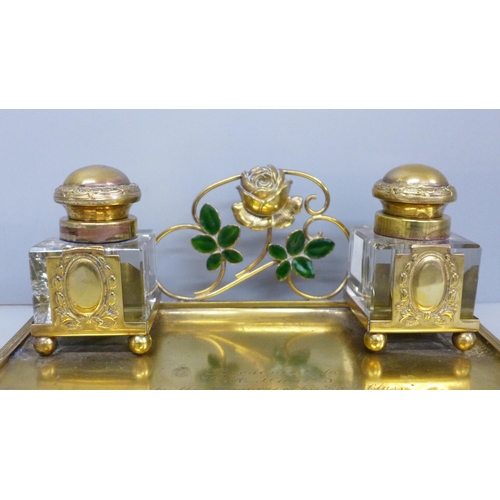 622 - A gilt metal inkstand with inscription, inkwells chipped