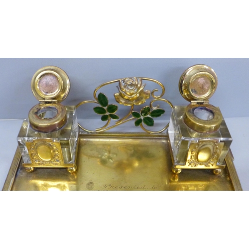 622 - A gilt metal inkstand with inscription, inkwells chipped