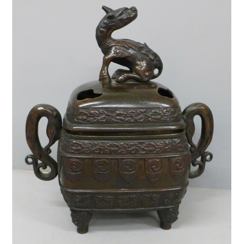 634 - A bronze incense burner with oriental detail and mythical creature to lid