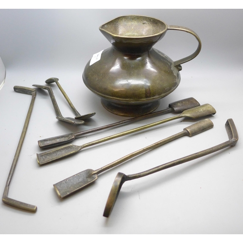 659 - A bronze jug and seven moulded tools