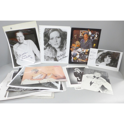 678 - A collection of approximately 40 celebrity photographs, most signed