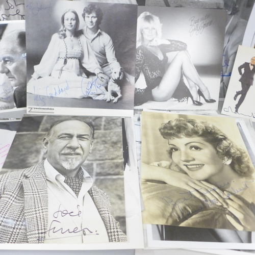 678 - A collection of approximately 40 celebrity photographs, most signed