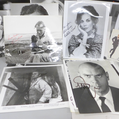 678 - A collection of approximately 40 celebrity photographs, most signed