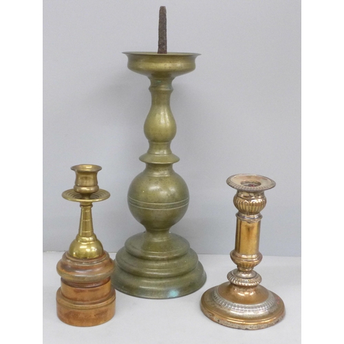 707 - Three candlesticks including one mounted on a wooden plinth