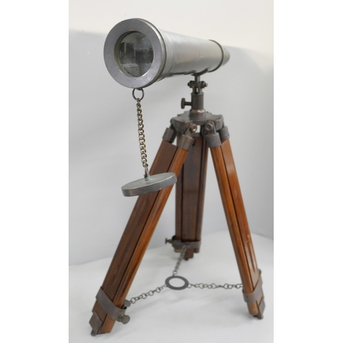 800 - A brass telescope on wooden tripod stand