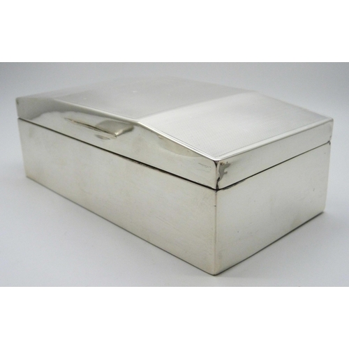 819 - A silver engine turned cigarette box, engraved date on the lid 23/6/37, 16.5 x 8.5cm, a miniature si... 