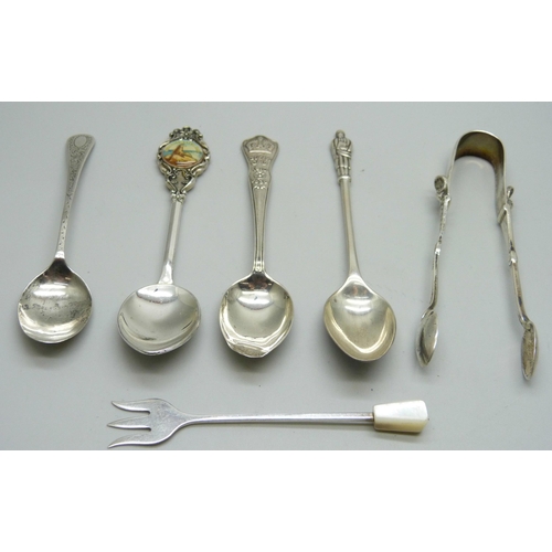 832 - A collection of silver spoons, sugar nips, and a pickle fork, 53g, together with a plated spoon