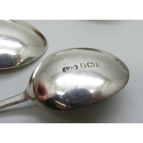 832 - A collection of silver spoons, sugar nips, and a pickle fork, 53g, together with a plated spoon