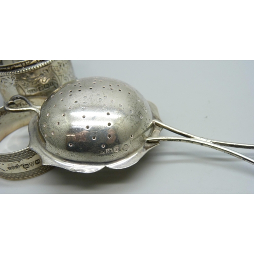 836 - A silver tea strainer and two silver napkin rings, 73g