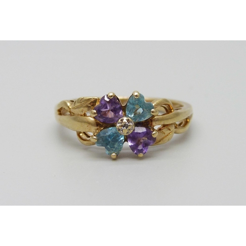 889 - A 9ct gold ring set with a small central diamond, amethyst and topaz, 2.9g, Q/R