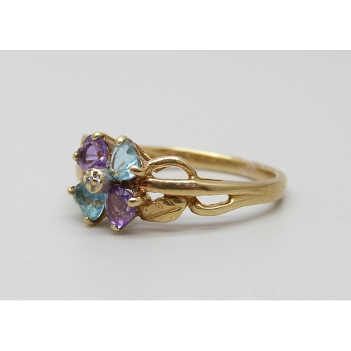 889 - A 9ct gold ring set with a small central diamond, amethyst and topaz, 2.9g, Q/R