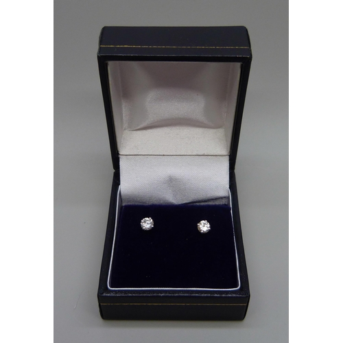 894 - A pair of hallmarked 18ct white gold diamond stud earrings, total diamond weight 0.50 carats