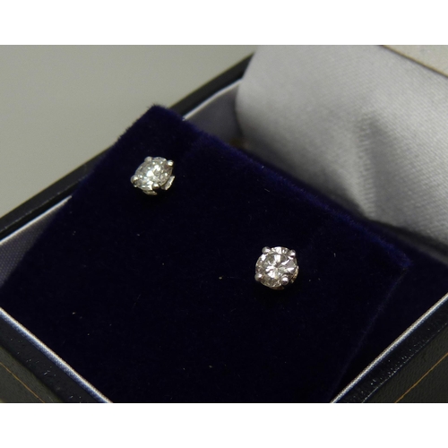 894 - A pair of hallmarked 18ct white gold diamond stud earrings, total diamond weight 0.50 carats