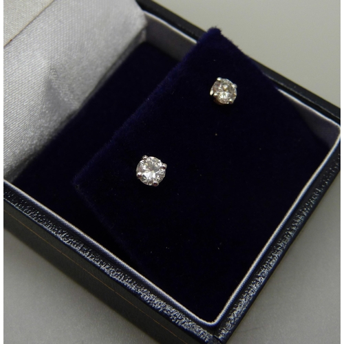 894 - A pair of hallmarked 18ct white gold diamond stud earrings, total diamond weight 0.50 carats