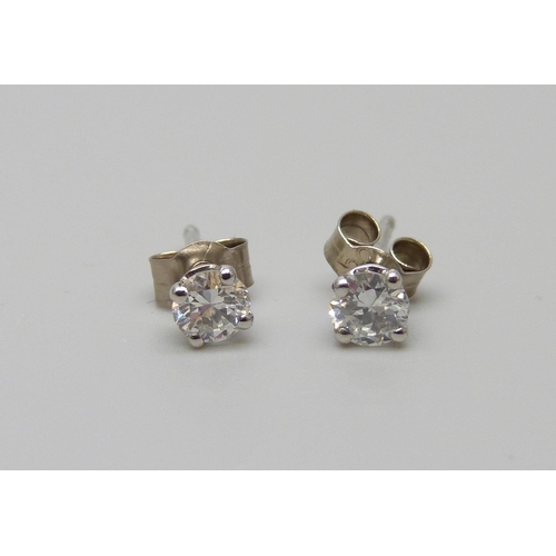 894 - A pair of hallmarked 18ct white gold diamond stud earrings, total diamond weight 0.50 carats