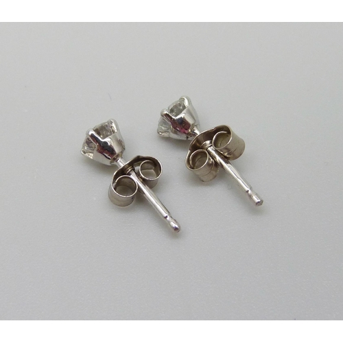 894 - A pair of hallmarked 18ct white gold diamond stud earrings, total diamond weight 0.50 carats