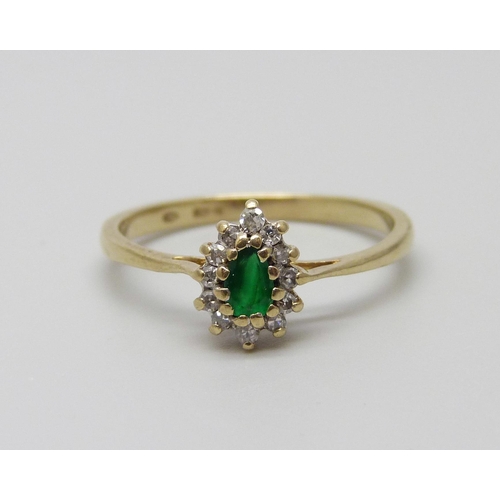 911 - A 9ct gold, diamond and emerald ring, 1.7g, N