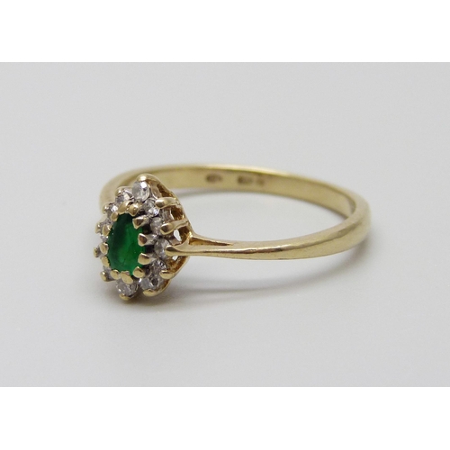 911 - A 9ct gold, diamond and emerald ring, 1.7g, N