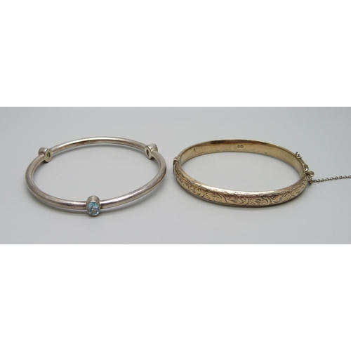 913 - Two silver bangles, one set with topaz, 22g total