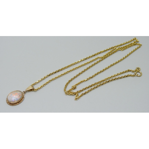 921 - A 9ct gold chain with a yellow metal set opal pendant, 9g total, 1.2 x 0.9cm opal, 60cm chain